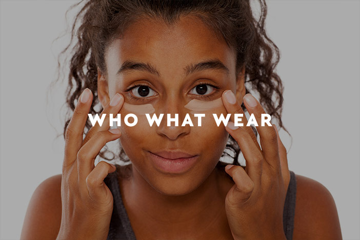 A younger woman applies eye cream to the under eye area to hide dark circles. A 'Who What Wear' logo is superimposed on top.