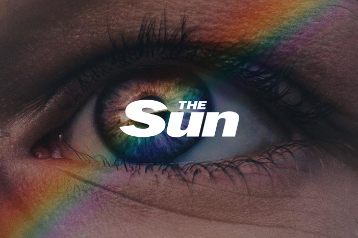 Woman stares at camera with The Sun logo superimposed on top.