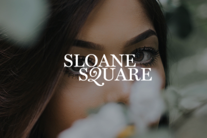 Woman looks at camera while spring blooms appear in the shot eith Sloane Square magazine logo is superimposed on top
