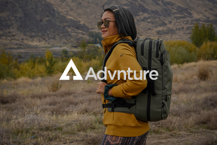 Younger woman hiking wearing glasses with Advnture logo imposed
