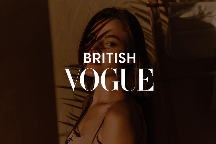 Dr Elizabeth Hawkes named in Lauren Stevenson’s wedding beauty team in British Vogue Woman in warm light with palm shadows on her face, featured in British Vogue article about Lauren Stevenson’s Ibiza wedding