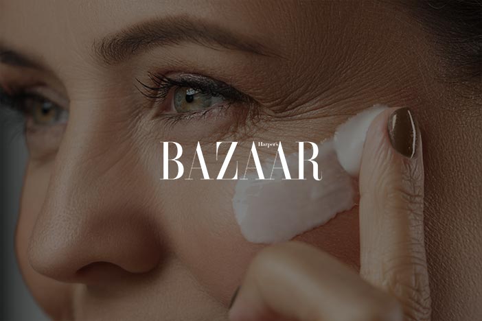 Dr Elizabeth Hawkes on collagen eye cream recommendations in Harper’s Bazaar Close-up of mature woman applying eye cream near crow’s feet area, featured in Harper’s Bazaar article about collagen eye creams