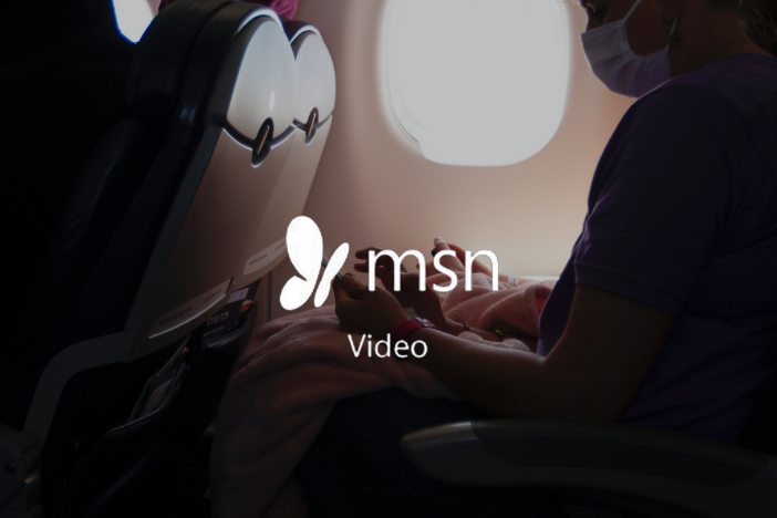 Woman on a plane with MSN Video logo imposed