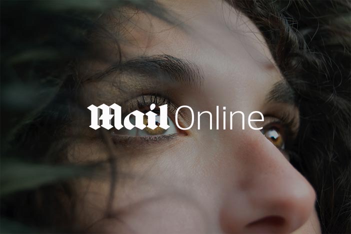 Woman stares upwards with the Mail Online logo superimposed on top.