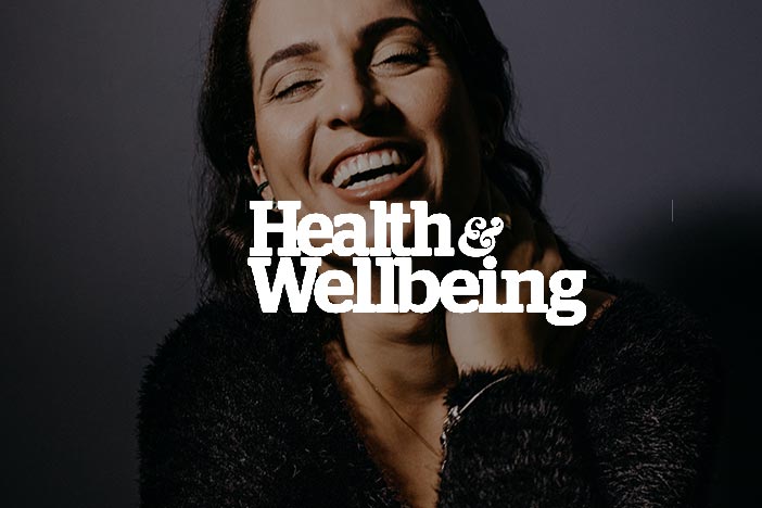 Older woman gazes down with a smile and Health & Wellbeing Magazine logo superimposed on top.