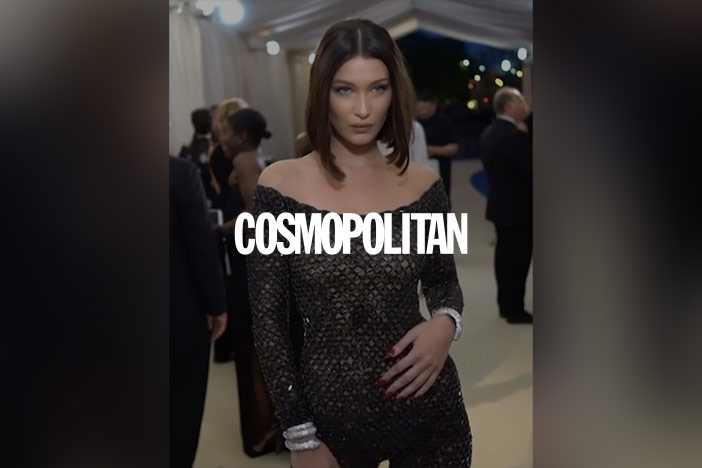 Bella Hadid dressed up for an event. The 'Cosmopolitan' magazine logo is superimposed on top.