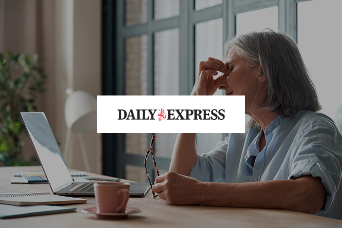 An older woman holds her eyes to signal pain with the Daily Express logo superimposed on top