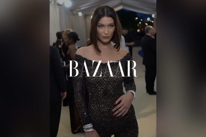 Bella Hadid is dressed up for an event with good skin. An 'Elle' logo is superimposed on top.