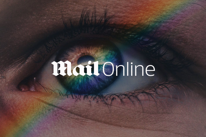 A close up of an eye that looks upwards with a rainbow and the Mail Online logo superimposed on top