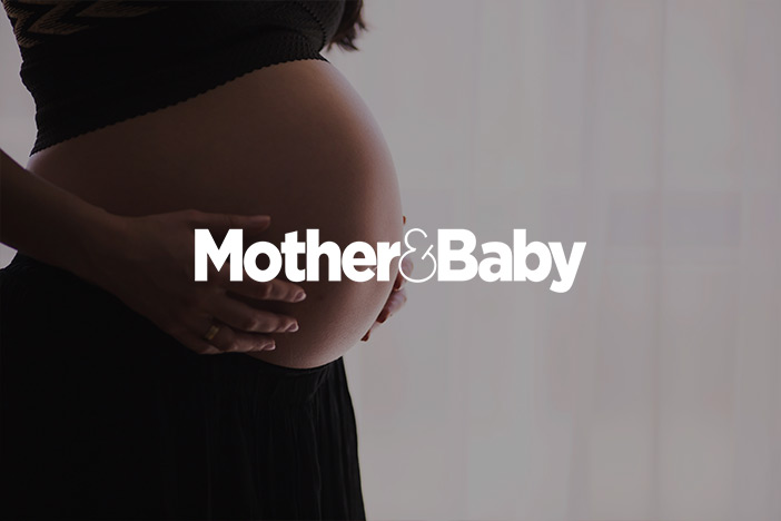 Pregnant woman holds her bare pregnant belly. The 'Mother & Baby' logo is superimposed on top.