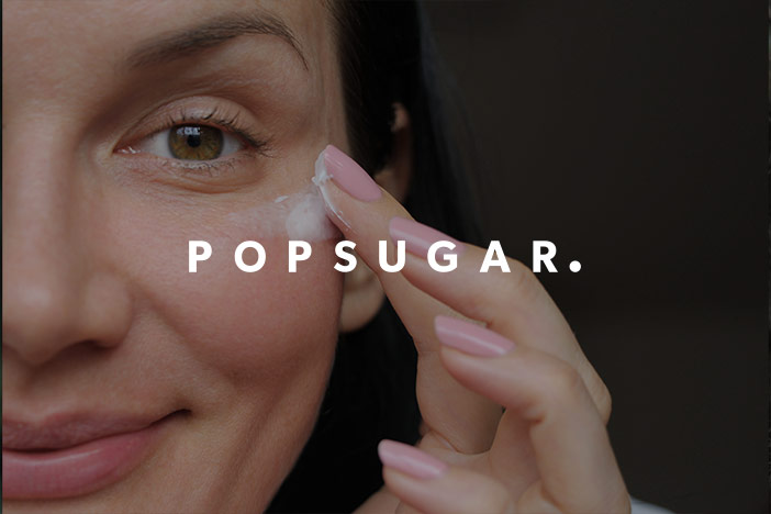 Middle aged woman applies eye cream under the eye. The 'Popsugar' logo is superimposed on top. 