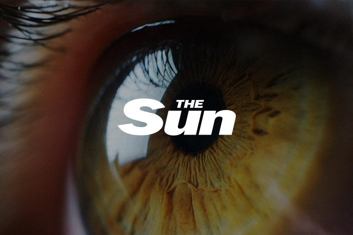 Macro image of a green eye looking into the distance. 'The Sun' Magazine logo is superimposed on top.