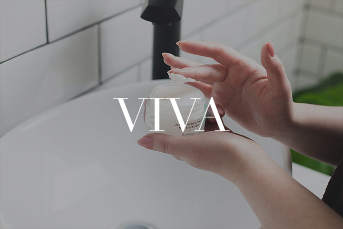 A woman begins to apply face cream with the Viva logo superimposed on top