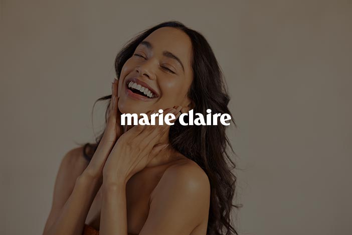 Smiling woman touching her face with eyes closed representing skincare and beauty for Marie Claire UK Skin Awards 2025