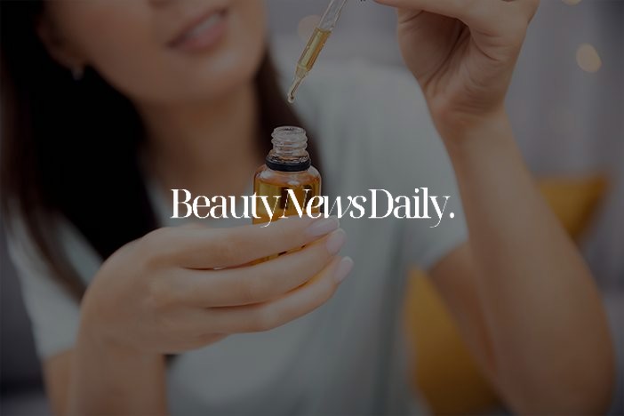 Woman applying serum from a dropper bottle, Beauty News Daily feature on M&S Formula