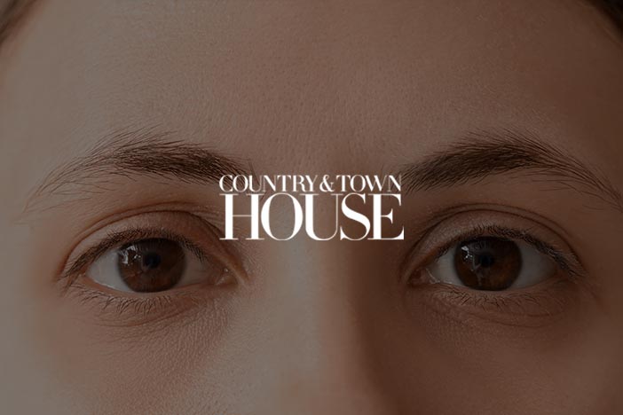 Close-up of a person's eyes with the 'Country & Town House' logo overlayed