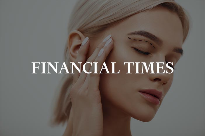 Dr Elizabeth Hawkes on rising demand for eyelid surgery in the Financial Times Woman touching her temple with surgery-style guide lines drawn on upper eyelid, featured in Financial Times article on the rise of eyelid lifts