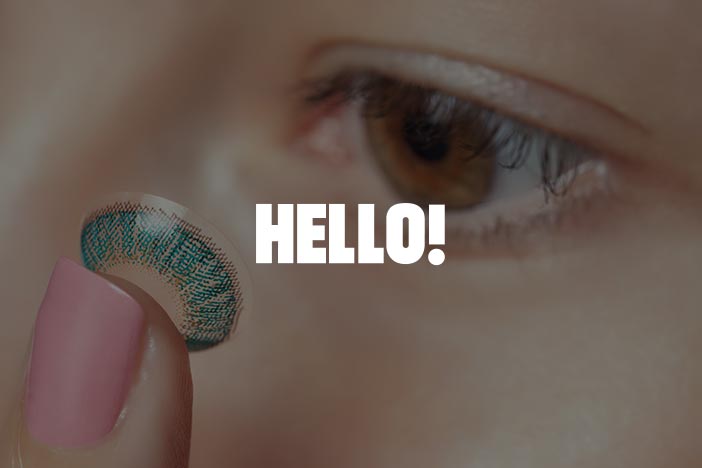 Dr Elizabeth Hawkes on coloured contact lens safety for Halloween in HELLO! Close-up of a person holding a patterned contact lens near their eye, featured in HELLO! article about celebrity Halloween costumes