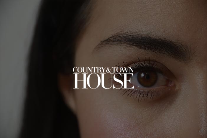 Close-up of a woman’s eye with defined lashes featured in Country & Town House article about the eye surgery trend