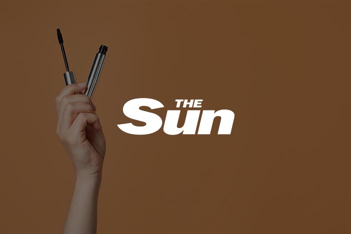 The Sun feature on mascara Close-up of a mascara tube with a hand holding it
