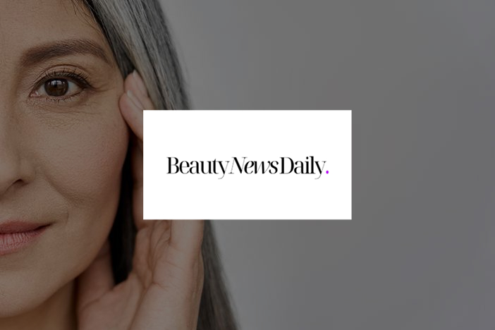 Dr Elizabeth Hawkes on cosmetic surgery trends in Beauty News Daily Close-up of mature woman with hand touching her face, featured in Beauty News Daily article on cosmetic surgery trends