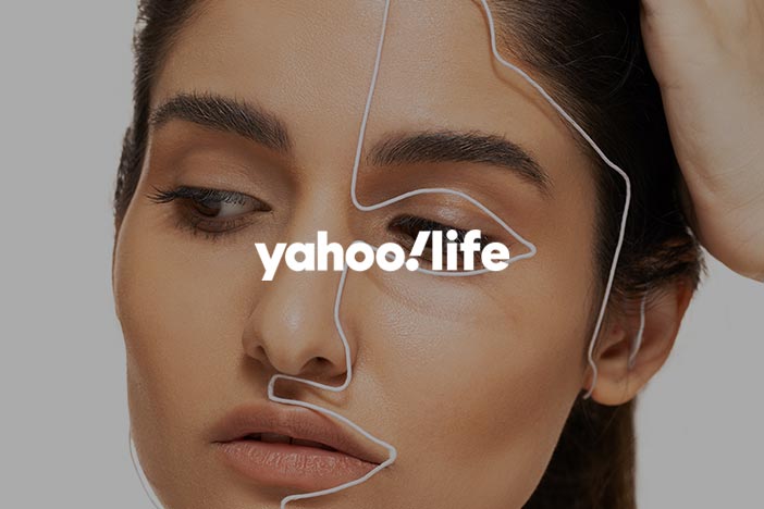 Young woman gazes down with Yahoo! Life logo superimposed on top.