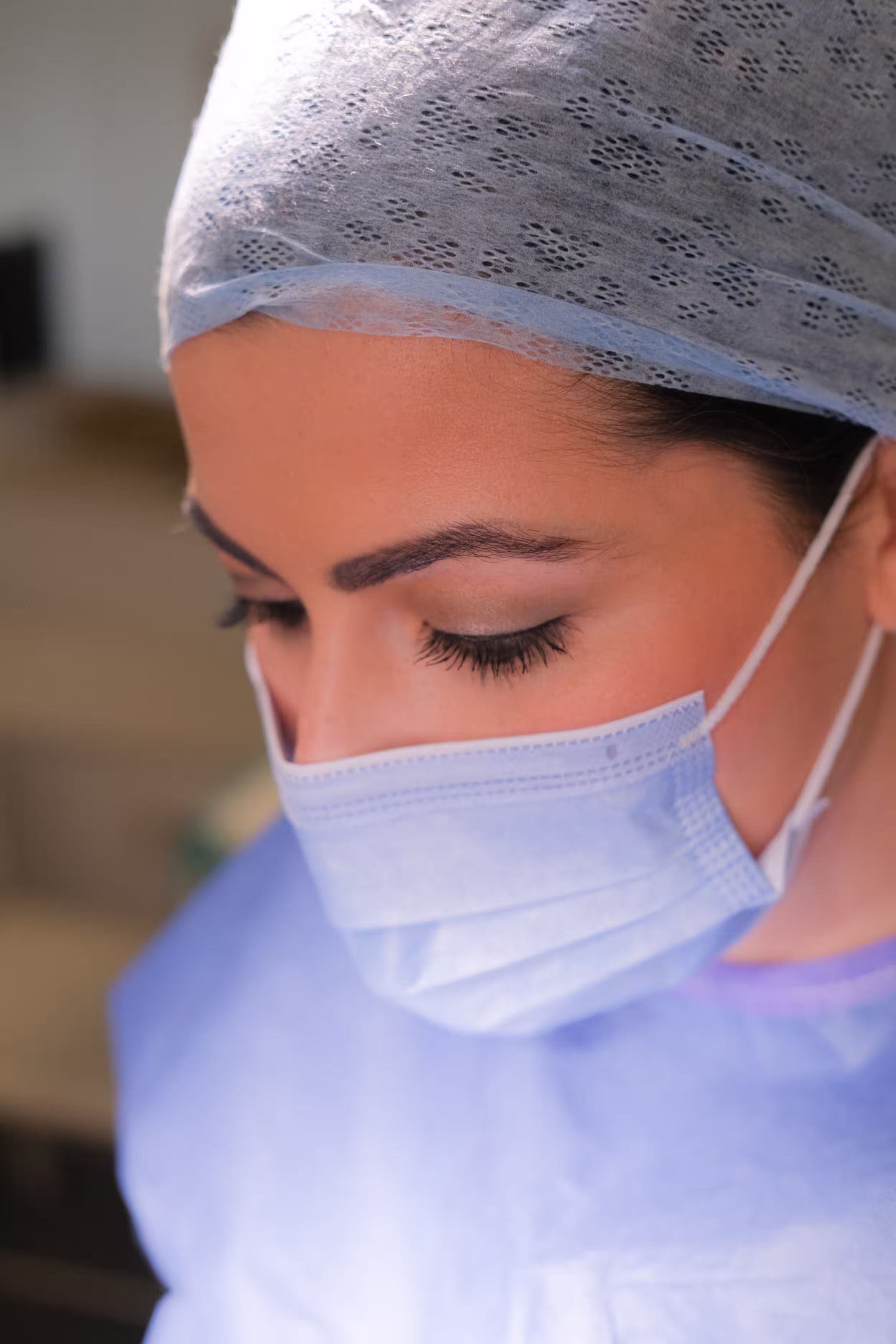 Dr Elizabeth Hawkes wearing surgical scrubs, Consultant Oculoplastic Surgeon