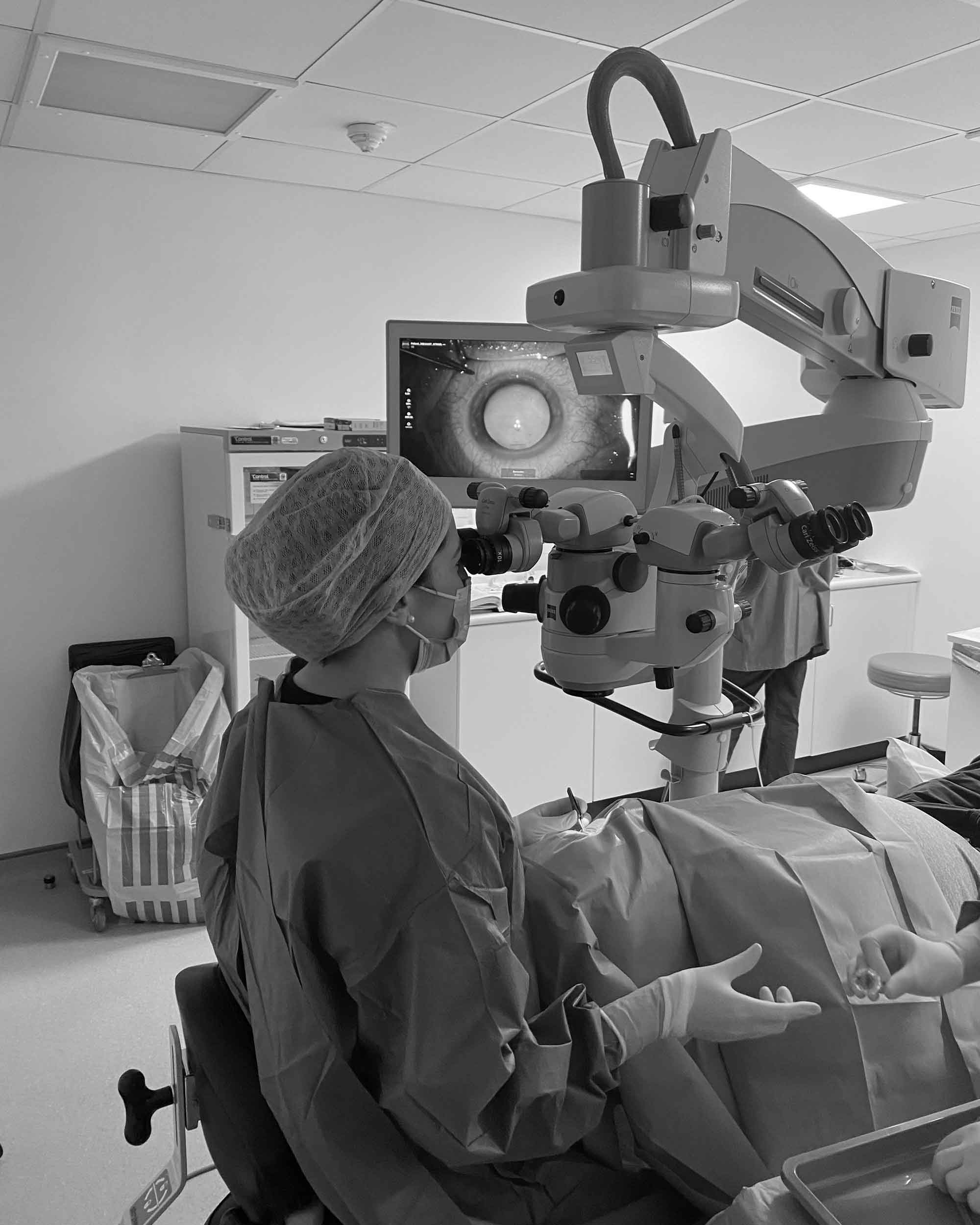 Dr Hawkes operating with a surgical microscope in theatre